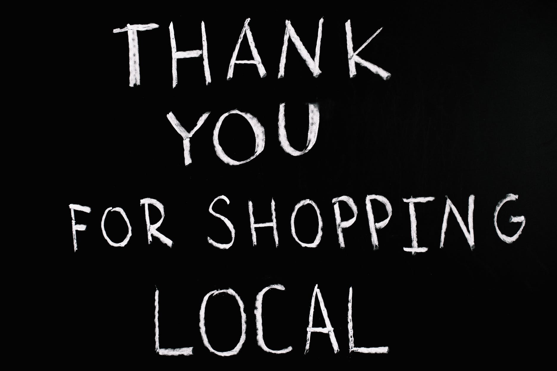 thank you for shopping local lettering text on black background for zero waste shop to help your sustainable new year resolutions